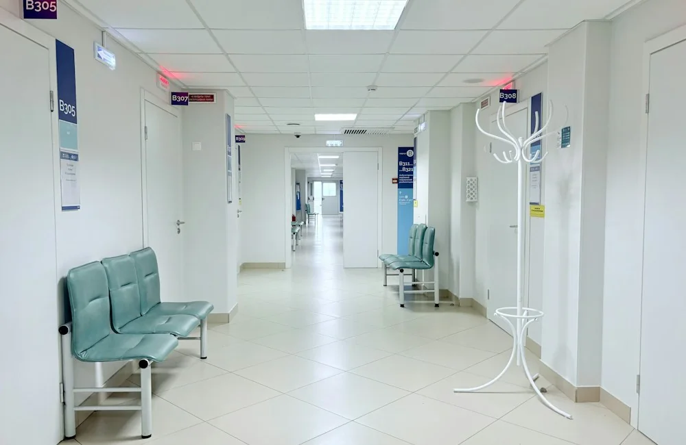 Healthcare facility corridor with clinical rooms and waiting areas